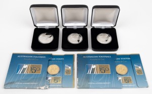 Group lot of five commemorative coins, comprising three 'MCG 1853 175 Years of Melbourne' nondenominational coins and two 'Australian Football 150 Years' $1 coins, all in original packaging. (5 items)
