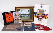 AFL CENTENARY: Group lot of items including Centenary Ball programme/menu, Centenary Ball commemorative booklet, leather pre-production football logo sample signed by Oakley, Centenary Stamp Booklet Collection with all clubs represented, set of sixteen po