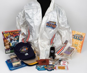 NFL: Group lot of 1990s branded promotional items, including six slabbed replica Superbowl tickets, five caps, thirty pins, 1999 Superbowl Pro Player rain jacket, Swiss army knife, sealed pack of trading cards, ephemera, and several others. (55+ items)