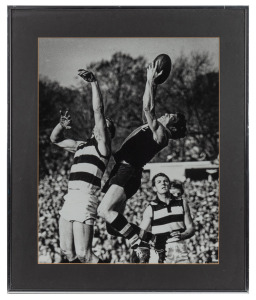 Two original photographs of Ross Oakley taking a mark during his time as a St Kilda player, one mounted 40 x 50cm with plaque that reads 'Ross Oakley with appreciation Hawthorn Football Club 1986', the other framed and glazed 53 x 63cm overall. (2 items)