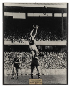 Two original photographs of Ross Oakley taking a mark during his time as a St Kilda player, one mounted 40 x 50cm with plaque that reads 'Ross Oakley with appreciation Hawthorn Football Club 1986', the other framed and glazed 53 x 63cm overall. (2 items) - 2