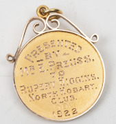 TWO NORTH HOBART FOOTBALL CLUB AWARDS TO RUPERT HIGGINS: an&nbsp;award fob in gold (9ct; 5.18g), by W (Willis), scroll and ring top suspension, reverse inscribed, 'Presented / By / Mr E.Preuss. / To/Rupert Higgins. / North Hobart /Club./ 1922'; and another awa - 5