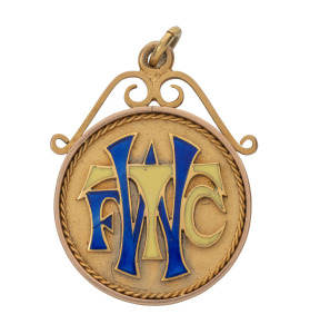 WEST TORRENS FOOTBALL CLUB, prize fob in gold and enamel (9ct, 13.32g); ring top suspension, the obverse with bold "W.T.F.C." in large enameled letters; the reverse inscribed "First Premiership - 1924 - Presented to / S. PATTEN. / by / supporters of the C