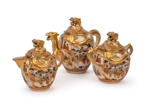SATSUMA antique Japanese earthenware three piece tea set with dragon spouts and finials, Meiji Period, 19th/20th century, black and gilt seal mark to base, ​​​​​​​the tea pot 18cm high, 20cm wide.