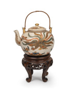 SATSUMA fine quality antique Japanese earthenware teapot with phoenix decoration, with carved wooden stand, Meiji Period, 19th century, 12cm high including handle, 19.5cm overall.