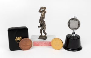 Three medals engraved with Barry Round's name - '3TR Raymond Motors Team of the Year - 1968', 1987 NFL Shield, and 1988 Australian Bicentenary 'Captain VFA Division Two Bi-Centennial Runner Up', plus 300th game congratulatory trophy.