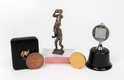 Three medals engraved with Barry Round's name - '3TR Raymond Motors Team of the Year - 1968', 1987 NFL Shield, and 1988 Australian Bicentenary 'Captain VFA Division Two Bi-Centennial Runner Up', plus 300th game congratulatory trophy.