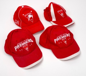 Group of four of Barry Round's Sydney Swans caps, comprising two Sydney Swans Premiers 2005, and two plain Sydney Swans.