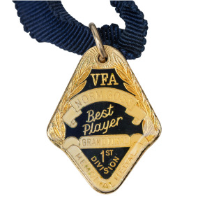 NORM GOSS MEMORIAL MEDAL: Barry Round's 1990 medal with text 'VFA NORM GOSS MEMORIAL MEDAL - Best Player GRAND FINAL 1st DIVISION'.