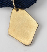 NORM GOSS MEMORIAL MEDAL: Barry Round's 1990 medal with text 'VFA NORM GOSS MEMORIAL MEDAL - Best Player GRAND FINAL 1st DIVISION'. - 2
