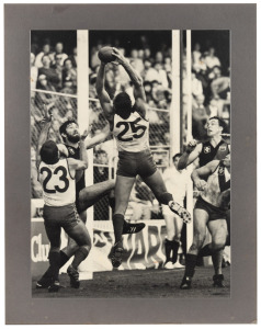 Three original photographs of Barry Round, two of which in action on field, block mounted, the largest 51 x 61cm.