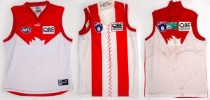 Three c. 2000s Sydney Swans guernseys, each with AFL logo and QBE Insurance branding.