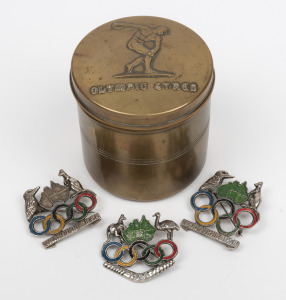 1956 MELBOURNE OLYMPICS: Brass cannister made by Stokes & Sons of Melbourne; together with three assorted brooches, (4 items), the cannister 8cm high