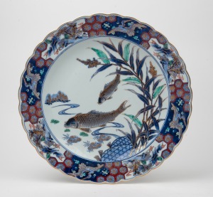 A Japanese Arita ware porcelain charger with koi carp and bamboo decoration, Meiji period, 19th/20th century, hand-painted seal mark to base, 42cm wide
