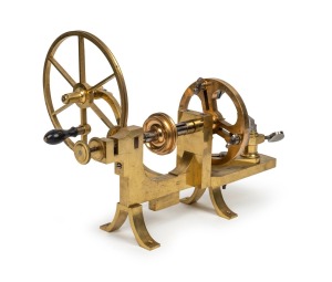 GRIMSHAW & BAXTER antique English brass watchmakers&rsquo; lathe with adjustable three jaw face plate and hand drive wheel with six crossings, 19th century, 37cm wide, 19.5cm diameter to the wheel
