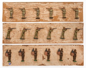 Three sets of six hand-painted lead soldiers affixed to card backing as issued, comprising American flag bearers, buglers, and riflemen, ​​​​​​​the largest 5.5cm high.