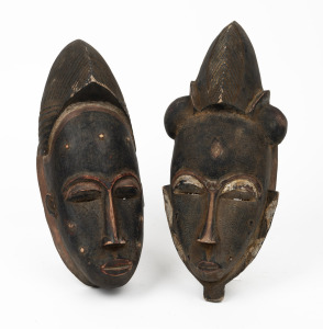 Two tribal masks, carved wood with remains of painted decoration, African origin, 20th century, ​​​​​​​32cm and 29cm high.