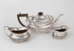 Three piece antique English sterling silver tea service, early 20th century, the teapot 13cm high, 30cm wide, 858 grams total including timber handle
