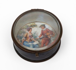 An antique French circular porcelain jewellery box with glass lid and gilt metal mounts, interior with hand-painted courting scene decoration, 19th century, 4cm high, 8cm diameter