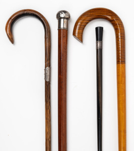 Four assorted antique walking sticks, including ebony with silver collar, Malacca with silver top and Australian fiddleback maple, 19th and 20th century, the longest 88cm high.