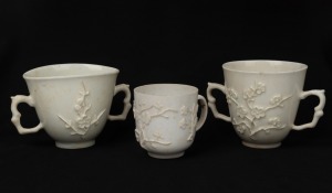 BOW antique English blanc de chine porcelain teacup and two double handled cups, with embossed prunus pattern, 18th century, (3 items), 5.5cm and 7cm high