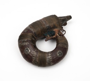 Yemeni tribal metal ware powder flask, 20th century, ​​​​​​​20cm wide.