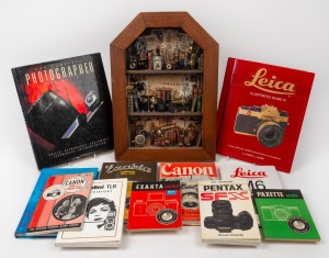 An attractive point of sale miniature camera diorama display; together with a selection of camera books and manuals, ​​​​​​​the diorama