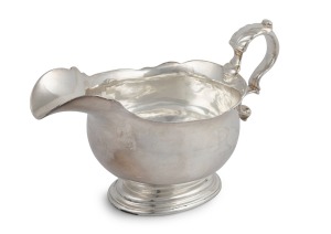 A George II antique English sterling silver sauce boat, stamped "J.S." made in London, circa 1736, 10cm high, 17cm wide, 262 grams.