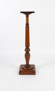 An antique English mahogany pedestal with turned and baluster column on plinth base, circa 1900, 123cm high, the top 26cm wide, 25cm deep
