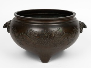 A Chinese bronze censer with dragon decoration and lion's head handles, 19th/20th century, 19cm high, 27cm wide