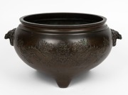 A Chinese bronze censer with dragon decoration and lion's head handles, 19th/20th century, ​​​​​​​19cm high, 27cm wide