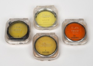 LEITZ: Group of four lens filters in Leitz plastic cases - one 1 HOOBE, one Or HOOGU, one 1 FIGRO, and one unidentified green filter with 'Ernst Leitz GmbH Wetzlar - 1 - Germany' markings. (4 items)