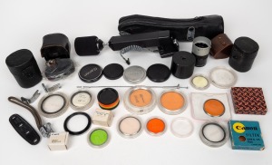 CANON: An accumulation of more than thirty Canon camera accessories, including eleven lens filters, two Demi Flash Units Couplers, four lens caps, and many others. (30+ items)