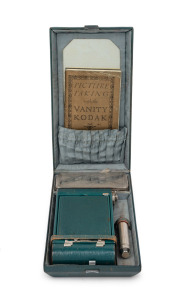 KODAK: Vanity Kodak Ensemble, c. 1928, comprising Vest Pocket Model B 127 film camera [#34553] in green, instruction booklet, lipstick, powder compact, mirror, and money pocket in leather case with strap.