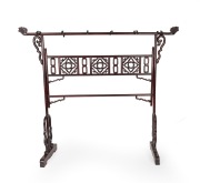 A Chinese stained hardwood hanging rack with scroll supports, fretted central rail and stylised bird head hanging posts, 20th century, 186cm high, 213cm wide, 55cm deep.