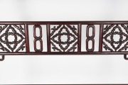 A Chinese stained hardwood hanging rack with scroll supports, fretted central rail and stylised bird head hanging posts, 20th century, 186cm high, 213cm wide, 55cm deep. - 2