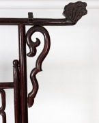 A Chinese stained hardwood hanging rack with scroll supports, fretted central rail and stylised bird head hanging posts, 20th century, 186cm high, 213cm wide, 55cm deep. - 3