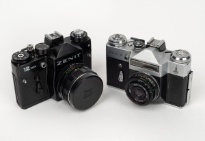 KRASNOGORSK: Group of two cameras - one Zenit-E with Industar-50-2 50mm f3.5 lens and leather half-case, together with one Zenit 12XP with Helios-44M-4 58mm f2 lens, Zenit lens cap, and leather half-case. (2 items)