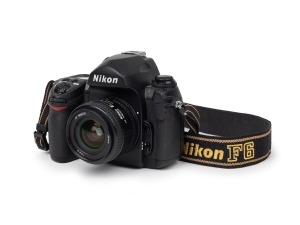 NIPPON KOGAKU: Nikon F6 SLR camera [#0009450] with AF Nikkor D 24mm f2.8 lens and Nikon F6 strap, c. 2004.