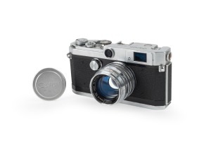 CANON: Canon L1 rangefinder camera [#551004] with Canon Serenar 50mm f1.8 lens [#74765], Canon lens cap, and Canon leather case, c. 1956.