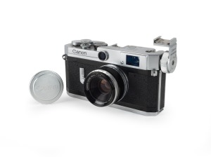 CANON: Canon VI-L rangefinder camera [#600436] with Canon 35mm f2.8 lens [#30137], Canon Flash Unit Coupler, and Canon lens cap, c. 1959.