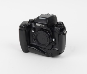 NIPPON KOGAKU: Nikon F4 SLR camera body [#2212822] with Nikon MB-21 battery grip and Nikon body cap, c. 1988.