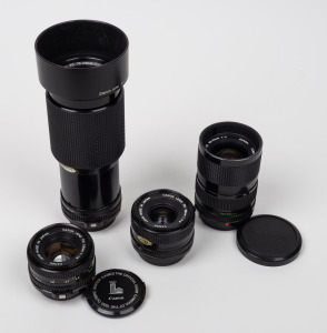 CANON: Group of four FD lenses (28mm f2.8/50mm f1.8/35-70mm f4/70-210mm f4) with various front and rear lens caps present. (4 items)