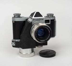 KAMERA-WERKST&Auml;TTEN: Praktina FX SLR camera with Carl Zeiss Jena Biotar T 58mm f2 lens [#3704848], Carl Zeiss Jena lens cap, spring-driven motor attachment [#03700] with "USSR OCCUPIED" stamp, and Kamera-Werkst&auml;tten leather case, c. 1956.