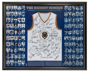 'THE HIGHEST HONOUR - CELEBRATING THE HISTORY OF THE BROWNLOW MEDAL' display produced by the AFL and the AFL Players Association, comprising head shots of all winners up to 2014. Featuring an oversized replica Brownlow Medal as centrepiece, a specially-designed guernsey with more than 50 original signatures of living medallists including Barry Round, Gary Ablett Jnr, Ross Smith, Paul Kelly, Ian Stewart, and Verdun Howell. Framed and glazed, 128 x 105cm overall, limited players' edition of 90.