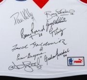 SWANS BROWNLOW MEDALLISTS: Display comprising Swans window-mounted guernsey with original signatures of Barry Round, Adam Goodes, Paul Kelly, Bobby Skilton, Greg Williams, Gerard Healy, Fred Goldsmith, Peter Bedford, and Graham Teasdale, framed and glazed - 2