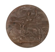 1896 ATHENS OLYMPIC GAMES participation medal in bronze, 50mm (58g) designed by N. Lytras and produced by Pittner in Austria. The medal depicts seated Nike holding a laurel wreath over a phoenix emerging from flames, the Acropolis is in background.