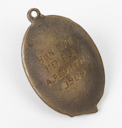An exceptionally rare COLLINGWOOD LIFE MEMBERSHIP FOB: A gilt bronze and enamel fob with the club's magpie at the centre of a belt & buckle strap containing the words "COLLINGWOOD FOOTBALL CLUB VICTORIA PARK"; the reverse engraved "HON. LIFE MEMBER / A.R. - 2