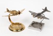 Two vintage aeroplane desk ornament ashtrays, in brass and aluminium, mid 20th century, 23cm and 20cm wingspans