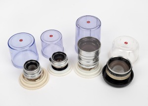 KODAK: Group of four Rodenstock lenses, all in transparent Kodak lens cases - one Retina-Rotelar 135mm f4, one Retina-Rotelar 85mm f4, one Retina-Eurygon 35mm f4, and one Retina-Longar-Xenon C 80mm f4. (4 items)